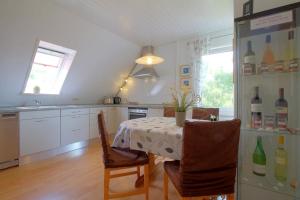a kitchen with a table and a refrigerator at KA8 Beim Wattn Fischer in Wremen