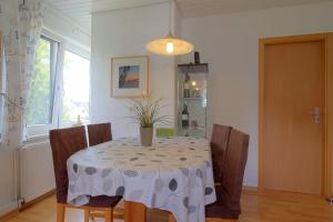 a dining room with a table and chairs and a window at KA8 Beim Wattn Fischer in Wremen +15 photos