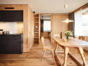 a kitchen and dining room with a wooden table at Alpe di Susi in Castelrotto