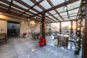 a patio with a table and chairs on it at Sunshine Pyramids& Grand Museum View in Cairo