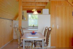 a dining room with a table and chairs at SR Eversand 11 in Dorum-Neufeld