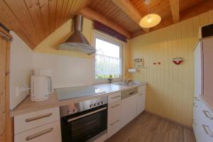 a kitchen with a sink and a stove at SR Eversand 11 in Dorum-Neufeld