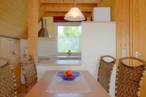 a kitchen with a table with a bowl of fruit on it at SR Eversand 11 in Dorum-Neufeld