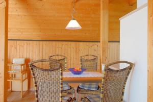 a dining room with a table and chairs at SR Eversand 11 in Dorum-Neufeld