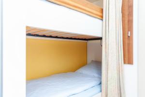 two bunk beds in a room with a yellow wall at Hanseatic 210 in Duhnen +4 photos