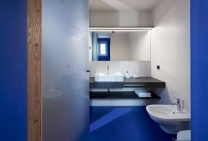 a bathroom with a white sink and a toilet at Alpe di Susi in Castelrotto +23 photos