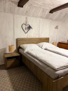 a bedroom with a large bed with a wooden headboard at Chata Rychnovanka in Zdobnice