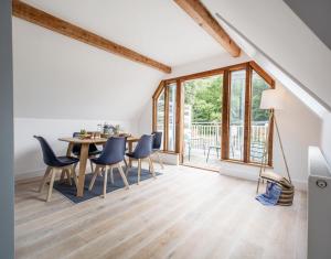 a living room with a dining room table and chairs at 1 Quay Cottage in Bawdsey