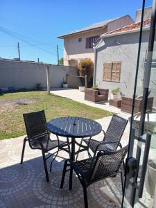 a patio with a table and two chairs and a table at Loft e casa Catarina in Imbituba