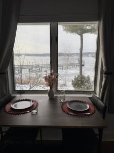 a table with two plates on it in front of a window at Pet friendly waterfront condo in Edgecomb