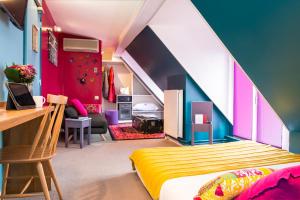 a bedroom with a bed and a room with an attic at H&ocirc;tel Villa Boh&egrave;me in Paris