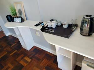 a white counter top with a coffee maker on it at Easy Inn Guesthouse in Welkom