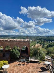 a brick building with tables and chairs on a patio at B&B Osteria Del Vicario in Certaldo +47 photos