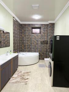 a bathroom with a tub and a toilet and a sink at Friends in Osh +37 photos