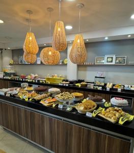 a buffet line with many different types of food at Florida Limeira Hotel in Limeira