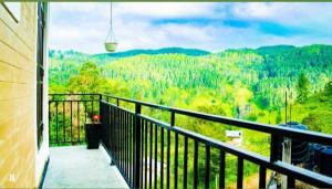 a balcony with a view of a forest at Wounder Mountain view ella in Medaperuwa