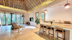a kitchen with a large island in a room with windows at YAM HOTEL in Mazunte