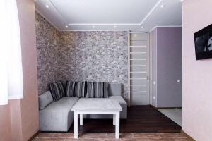 a living room with a couch and a table at Apartment-Lawina in Sumy