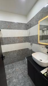 a bathroom with a sink and a mirror at Status Club in Hardoī +8 photos
