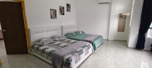 a bedroom with two beds in a room at Tetiba Suite in Muar