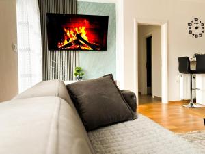 a living room with a couch and a fireplace at Apartman Sučić in Livno