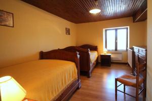 a bedroom with two beds and a window at Vedeix in Saint-Auvent +6 photos