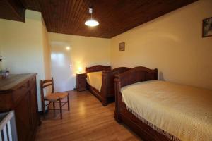 a bedroom with two beds and a table and chairs at Vedeix in Saint-Auvent