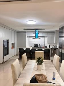 a kitchen and dining room with a table and chairs at Hillview Executive Self-Catering House in Blantyre