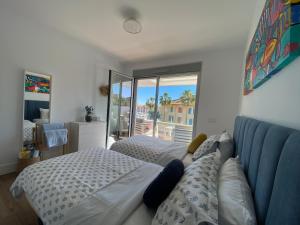 a bedroom with a bed and a couch and a window at La Marina Sotogrande Pier2 in Torreguadiaro +31 photos