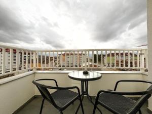 a balcony with two chairs and a table on a balcony at Apartman Sučić in Livno