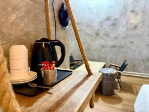 a tea kettle sitting on a wooden table at Ardour Lodge "A" Wing in Tanjung Bungah +95 photos