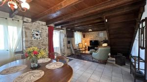 a living room with a wooden table and a living room at Le gîte de nathye in Saint-Junien