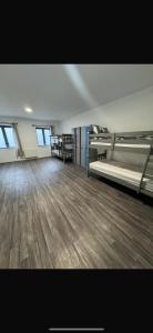 an empty room with two beds and a wooden floor at Dublin Quayside Hostel in Dublin