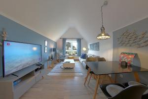 a living room with a large flat screen tv at Sie4-11 in Dorum-Neufeld
