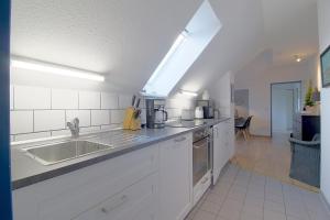 a kitchen with a sink and a counter top at Sie4-11 in Dorum-Neufeld +12 photos