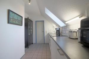 a large kitchen with white counter tops at Sie4-11 in Dorum-Neufeld