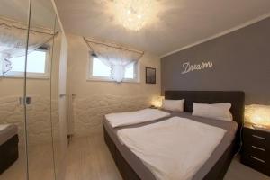 a bedroom with a bed and a glass shower at Apartment 256 in Hohegeiß +1 photo