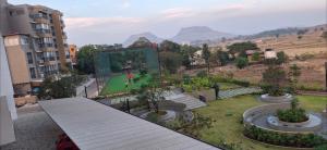 a man playing a video game in a building at Soni & Avi View Apartment in Igatpuri