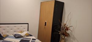 a bedroom with a bed and a wooden cabinet at Soni & Avi View Apartment in Igatpuri +3 photos