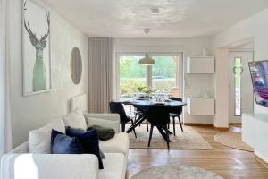 a living room with a white couch and a table at Admiral in Lübbenau
