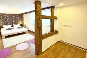 a living room with a bed and a window at An der Postmeilensäule in Lübbenau +18 photos