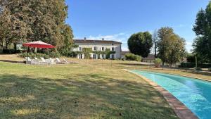 a house with a swimming pool in front of a house at Domaine de gensignac in Séreilhac
