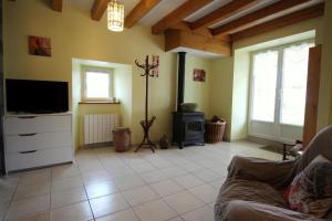 a living room with a couch and a tv and a fireplace at Mazette in Videix