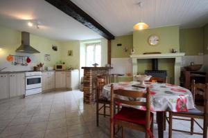 a kitchen with a table and a dining room at Mazette in Videix