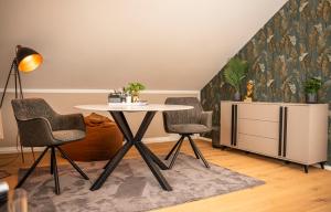 a dining room with a table and two chairs at Alb Appartement - gemütliche Wohnung mit Balkon in Balingen