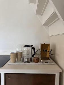 a kitchen counter with a coffee maker and pots and pans at Maison 1882 in Hauwert