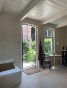 a living room with a table and a window at Maison 1882 in Hauwert