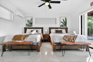 a bedroom with two beds and a ceiling fan at Hollywood Heated Pool Mini Golf Unique VR Room in Hollywood