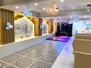 a hall with a dance floor and balloons at Evesta Micasa in Haridwār