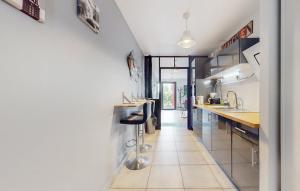 a kitchen with white tile flooring and a counter at STUDIO 88 in Sainte-Adresse +19 photos